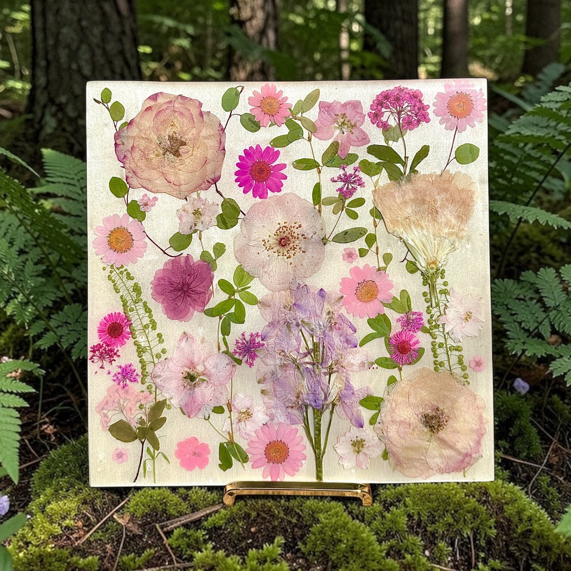 Floral painting on an easel in a forest setting